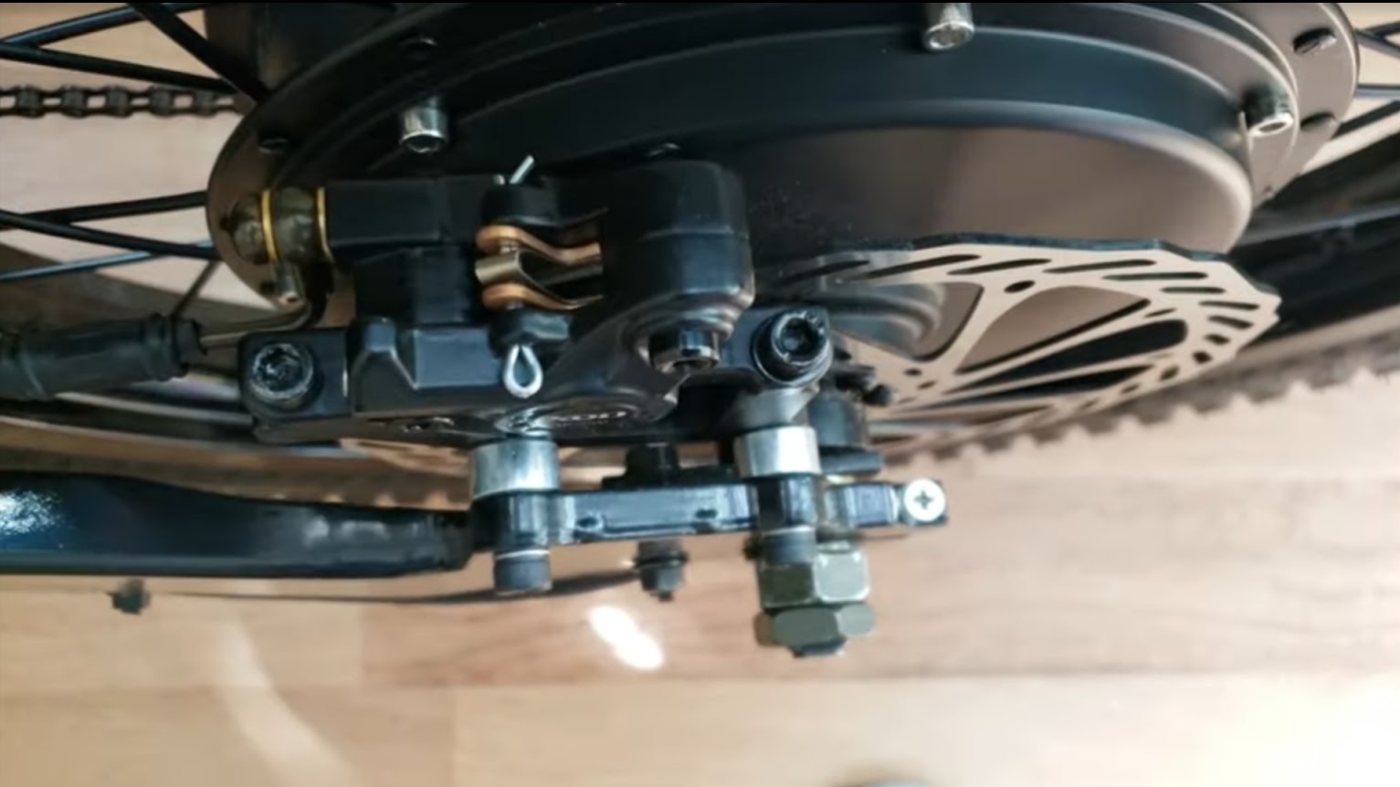 Rear hub motor with disc brake caliper